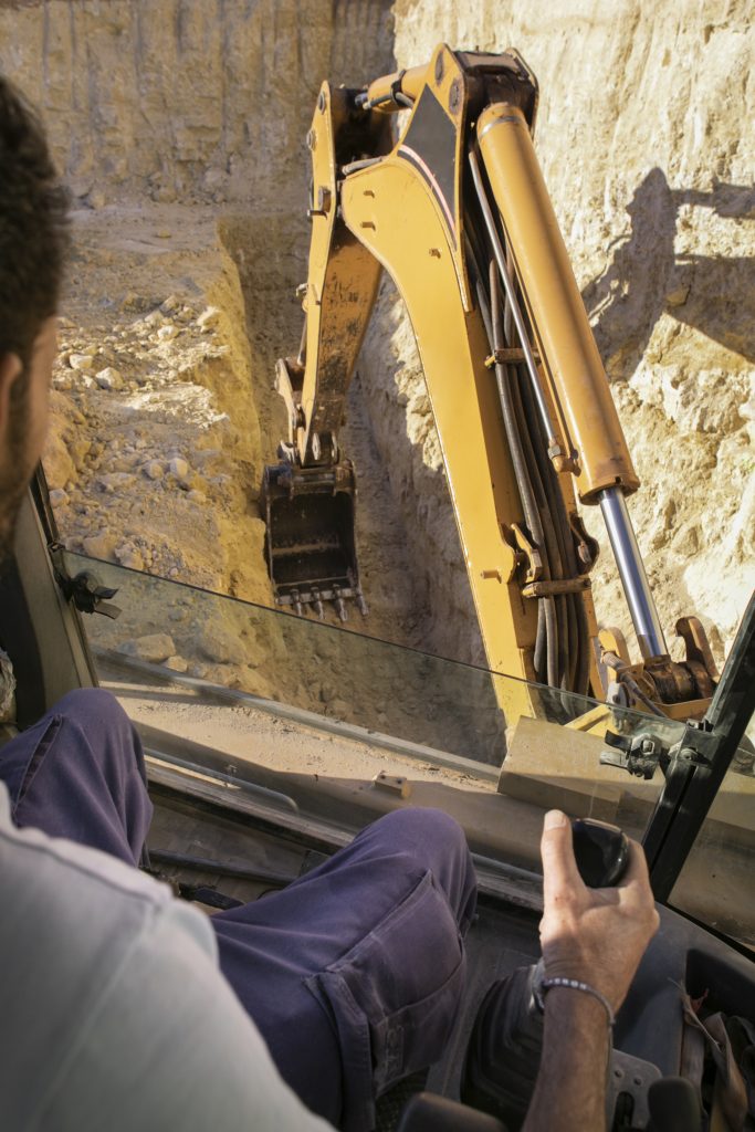 man using excavator digging day light